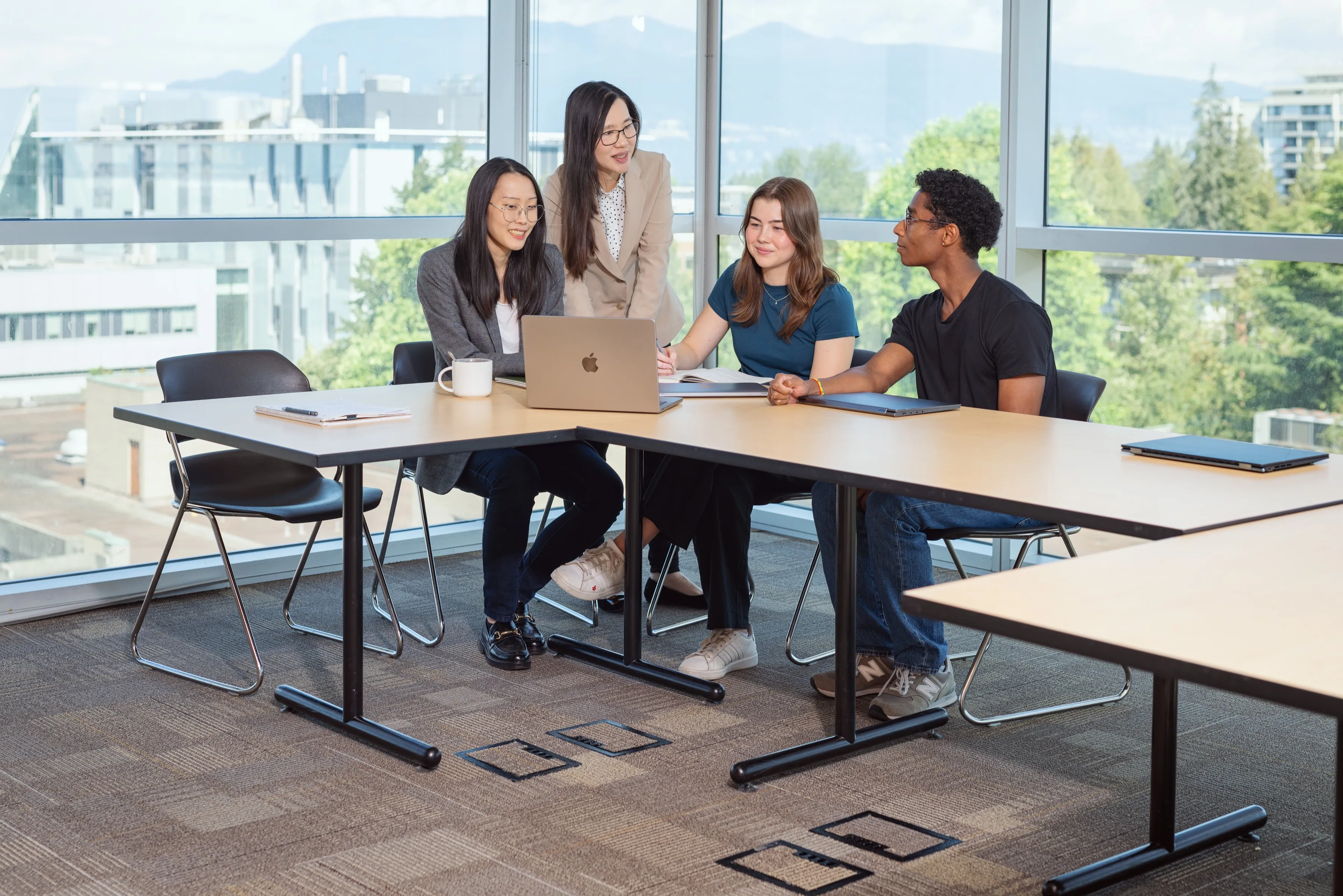 Lab members gathered around a table discussing work